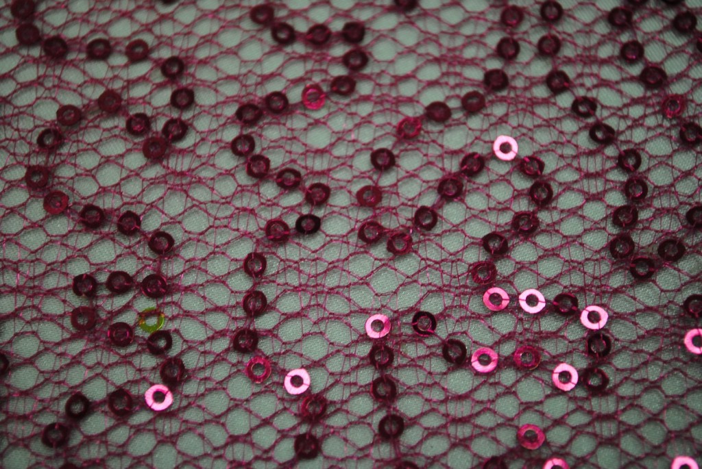 Fuchsia sequins on spider mesh fabric - Fabric Universe