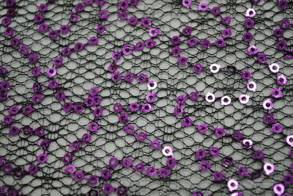 Purple sequins on black spider mesh fabric - Fabric Universe