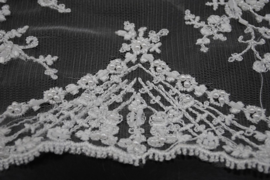 White bridal lace fabric with hand sewn beads
